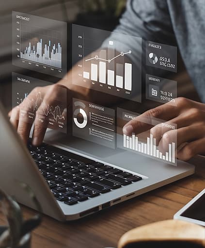 Analytics dashboards floating above a laptop keyboard with charts and performance metrics.
